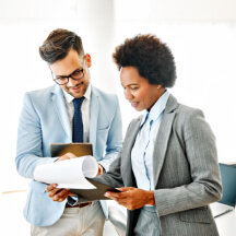 Colleagues reviewing printed documents.
