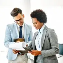 Colleagues reviewing printed documents.