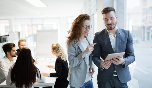colleagues reviewing tablet in office