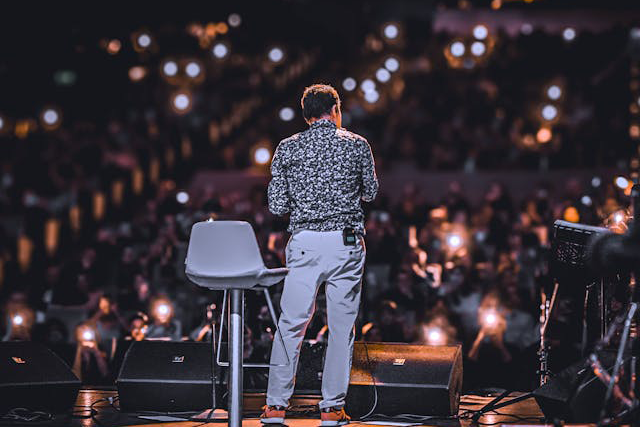 speaker addresses illuminated audience