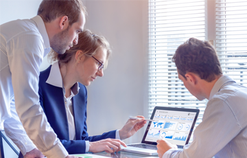 team analyzing data on laptop